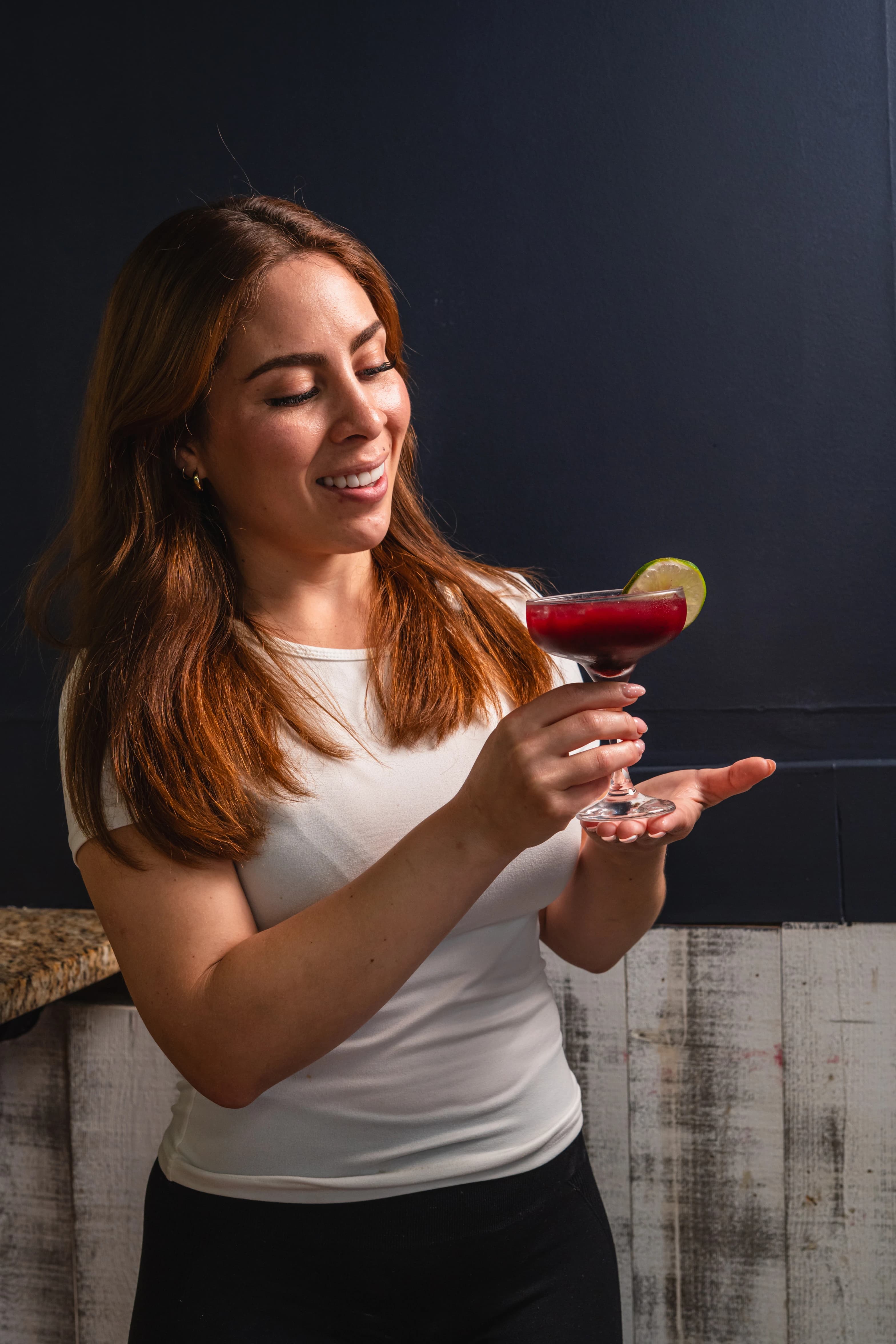 A guest raising a drink at Alta Brasa